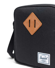 Load image into Gallery viewer, Front close up of the black cross body bag with Herschel logo tag.
