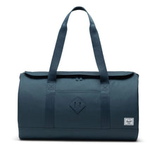 Load image into Gallery viewer, Front view of the Orion Blue duffle bag with the grab handles extended.