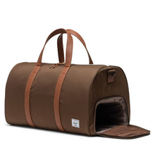 Load image into Gallery viewer, Angled view of the dark earth brown duffle bag. The side panel's shoe compartment is unzipped.