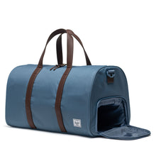 Load image into Gallery viewer, The steel blue Novel duffle bag with the side panel's shoe compartment unzipped.