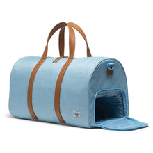 Load image into Gallery viewer, Angled view of the bluebell duffle bag. The side panel's shoe compartment is unzipped.
