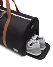 Load image into Gallery viewer, Close up to the side panel compartment with a pair of shoes inside.