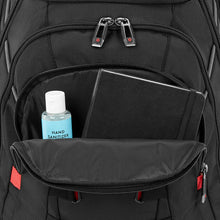 Load image into Gallery viewer, Close up to the front panel with the lower pocket unzipped. A hand sanitizer bottle and notebook are tucked inside.