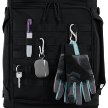 Load image into Gallery viewer, Close up to the carabiner straps on the black duffle bag. A pair of gloves, ear buds, a marker, and a key are attached to it.