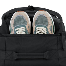 Load image into Gallery viewer, Close up to the top panel. A pair of shoes is peeking from the opened zipper compartment.