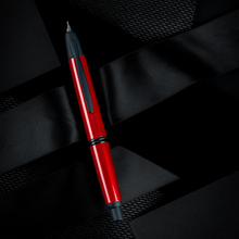 Load image into Gallery viewer, Front view of the fountain pen on a textured black background.