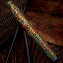 Load image into Gallery viewer, Front view of the fountain pen set on an arrangement of red-brown background objects. The pen depicts the detailed illustration of a man lovingly carrying his wife on his back. Underneath, an elaborate painting of a small peacock is shown. They are surrounded by a green background of flora and fauna.