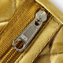 Load image into Gallery viewer, Close up to the zipper of a compartment on the gold-colored roll.