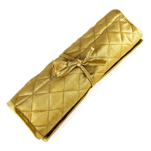 Load image into Gallery viewer, Angled view of the golden-colored jewelry roll, tied with a bow. Set on a white background.