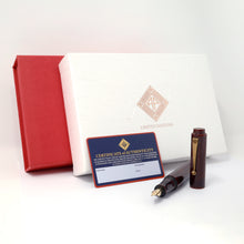 Load image into Gallery viewer, Arrangement of the red outer display box, the white outer box, the blue certificate of authenticity card and the fountain pen with the cap set to the side. Placed on a white background.