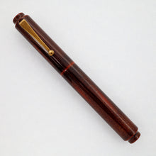 Load image into Gallery viewer, Front view of the Fountain pen with the cap on. Set on a white background. The pen is an almost dark-cherry red with sprinkled gold dust on the cap and barrel. The cap's clip is coated in gold dust.