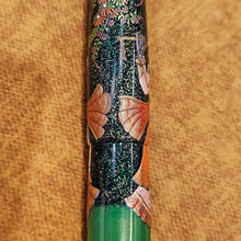 Load image into Gallery viewer, Close up to the pen. Set on an orange textured background.