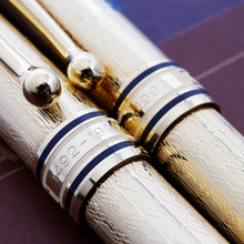 Load image into Gallery viewer, Close up to the cap rings. The text "1492-1992" is engraved on each under the clip.