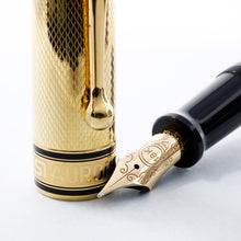 Load image into Gallery viewer, Close up to the nib and cap. Set on a white background. The Nib is 18k 750 yellow gold and features engraved decorations.