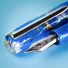 Load image into Gallery viewer, Close up to the fountain pen nib and cap. Set on a light blue background.