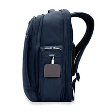 Load image into Gallery viewer, Briggs & Riley Baseline Traveler Backpack - Navy
Side Angle view showing Power Pocket, should you wish to charge your smart phone on the go (charger, cables, and smart phone not included).
Height Width Depth Weight
US 18 in. 12 in. 8.8 in. 3.3 lbs.
EU 45.7 cm 30.5 cm 22.4 cm 1.5 kg