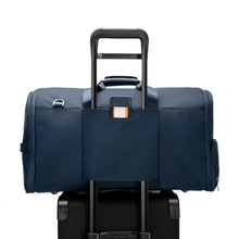 Load image into Gallery viewer, Briggs & Riley Baseline Garment Bag Duffle - Navy
Image of Attachment Feature, allowing this garment duffle to ride along the telescoping handle of your carry-on trolley bag
Height	Width	Depth	Weight
US	12.5 in.	22 in.	9 in.	4.2 lbs.
EU	31.8 cm	55.9 cm	22.9 cm	2 kg