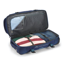 Load image into Gallery viewer, Open navy High Sierra wheeled duffel with drop bottom compartment packed.