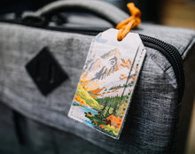 Load image into Gallery viewer, Luggage tag with mountain design attached to a gray suitcase