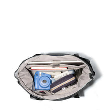 Load image into Gallery viewer, Top view of the bag with accessories organized on the inside.  Set on a white background.