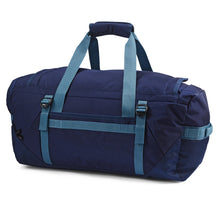 Load image into Gallery viewer, Side view of the navy blue duffle backpack with the grip handles pulled up.