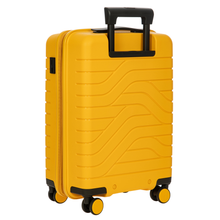 Load image into Gallery viewer, Angled back view of the mango-yellow carry-on suitcase on a white background.