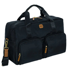 Load image into Gallery viewer, Angled front view of the duffle on a white background. It is black with tan leather accents.