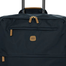 Load image into Gallery viewer, Close up to the top front of the suitcase. This side features two zipper compartments .