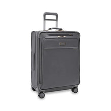 Load image into Gallery viewer, Angled front view of the suitcase with the telescopic handle partly pulled up.