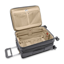 Load image into Gallery viewer, The suitcase laid on its back with the main compartment shown opened. The expandable feature is extended.