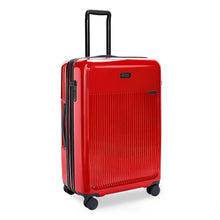 Load image into Gallery viewer, Angled front view of the red suitcase with black accents. The telescopic handle is pulled up.
