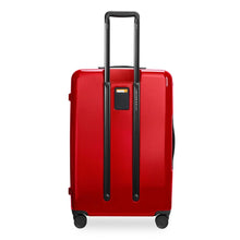 Load image into Gallery viewer, Back panel view of the red suitcase with black accents. The telescopic handle is pulled up. A contact tag is available in the middle.