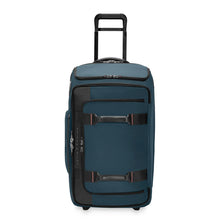 Load image into Gallery viewer, Front panel view of the ocean blue wheeled duffle bag with the telescopic handle extended.