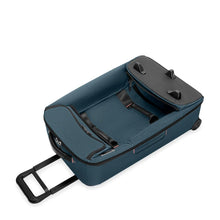 Load image into Gallery viewer, Angled front panel view of the ocean blue wheeled duffle, folded for storage.