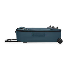 Load image into Gallery viewer, Side panel view of the folded ocean blue wheeled duffle,