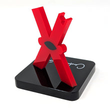 Load image into Gallery viewer, Angled back view of the red letter 'X' figure on a black base. The base has Ciudad Juarez printed in white in a hand-written font.