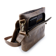 Load image into Gallery viewer, DayTrekr Distressed Leather Slim Crossbody Tablet Messenger - Brown
Image of Angled View, showing front pocket unzipped with convenient interior organization for smart phone, passport, boarding pass, etc.
Dimensions: 11.5 x 10 x 1