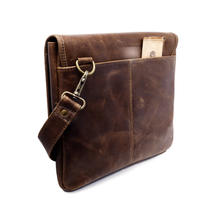 Load image into Gallery viewer, DayTrekr Distressed Leather Slim Crossbody Tablet Messenger - Brown
Image of Back panel view, showing Antique Brass Hardware. Also featuring back panel slip pocket for quick access to boarding pass, flight itinerary, etc.
Dimensions: 11.5 x 10 x 1"