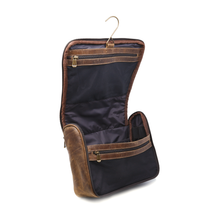 Load image into Gallery viewer, DayTrekr Hanging Toiletry Kit - Brown Distressed Leather
Toiletry kit shown in hanging view, and fully unzipped. Inside Antique brass hanger hook and two inside zippered mesh pockets. Spacious main compartment for all your toiletry essentials.
Dimensions: 11"(w) x 9"(h) x 4"(d)