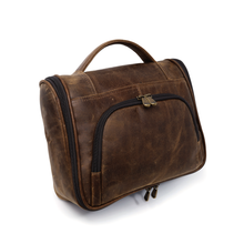 Load image into Gallery viewer, DayTrekr Hanging Toiletry Kit - Brown Distressed Leather
Front Angled View showing U-Shaped Zippered Opening into front panel organizer pocket. Matching Leather top handle grip.
Dimensions: 11"(w) x 9"(h) x 4"(d)