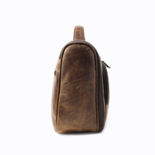 Load image into Gallery viewer, DayTrekr Hanging Toiletry Kit - Brown Distressed Leather
Left Facing Side Panel View. Matching Leather top handle grip.
Dimensions: 11"(w) x 9"(h) x 4"(d)
