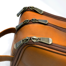 Load image into Gallery viewer, Close up to three sets of of brass zipper pulls.