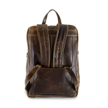 Load image into Gallery viewer, DayTrekr Distressed Leather Bombardier Backpack - Brown
Image of Back Panel View, with attachable feature allowing this backpack to ride along the telescoping handle of most cabin trolley bags.
Dimensions: 18"h x 13"w x 7"d