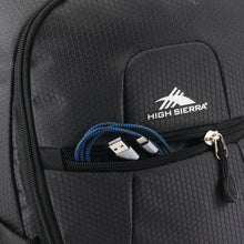 Load image into Gallery viewer, Close up to the front panel pocket with a cellphone charging cable peeking out.