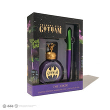 Load image into Gallery viewer, Angled front view of the Joker fountain pen and ink bottle set inside the matching packaging. DC, Batman and Warner Brothers logos are shown at the bottom left.