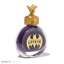 Load image into Gallery viewer, Angled front view of the purple with green shimmer ink bottle. The golden decorative cap has the head of the Joker with a hat.