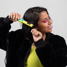 Load image into Gallery viewer, A young woman curling her hair.