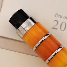 Load image into Gallery viewer, Close-up of a pen with an orange body, and silver accents on a light background.