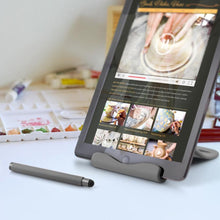 Load image into Gallery viewer, The tablet held by the stand with the stylus in front.