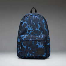 Load image into Gallery viewer, Front panel view of the blue toned Cheetah Camo Pattern backpack with a black Herschel logo tag at the bottom.